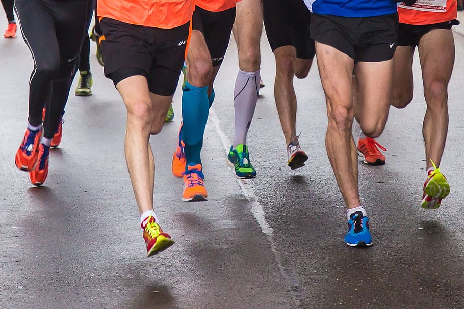 group of people running on road