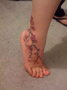 red flower tattoo on ankle 