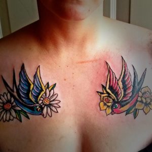 swallow or sparrow  colorful tattoo on chest