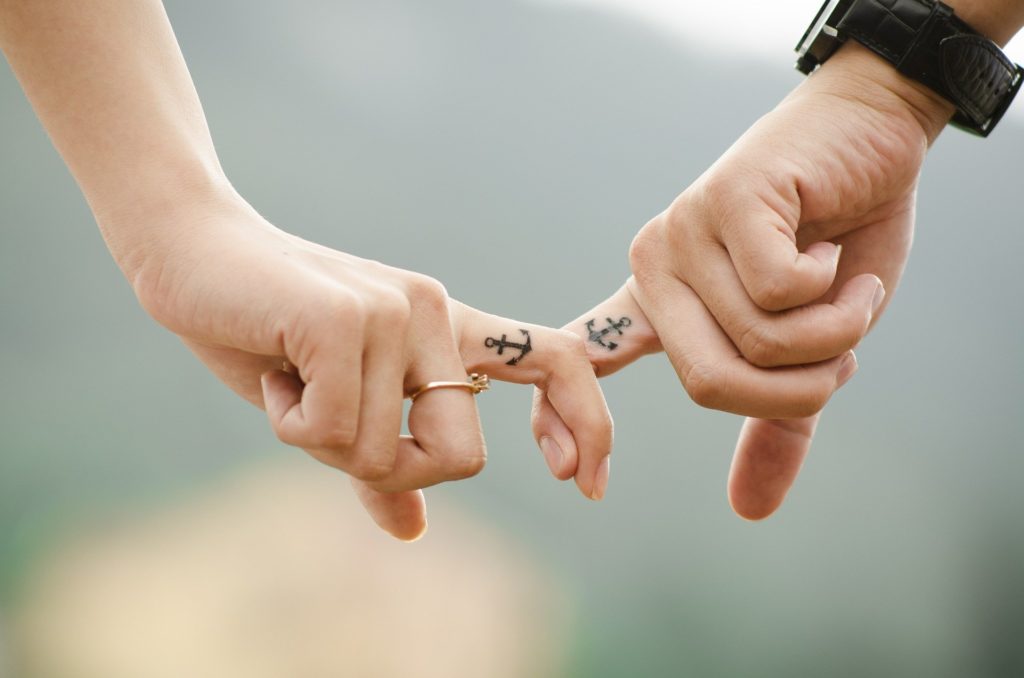 Micro anchor tattoos on fingers