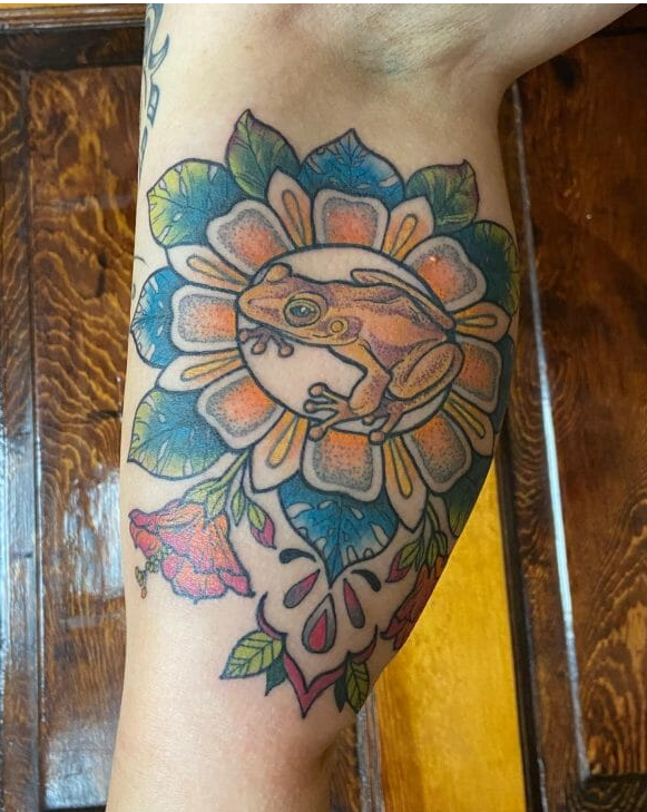 Flower and frog tattoo on calves