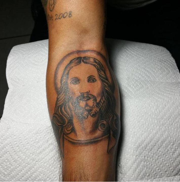 black jesus forearm tattoo