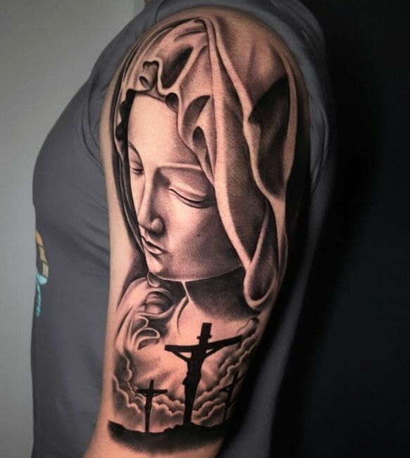 Virgin Mary forearm tattoo with crucified Jesus