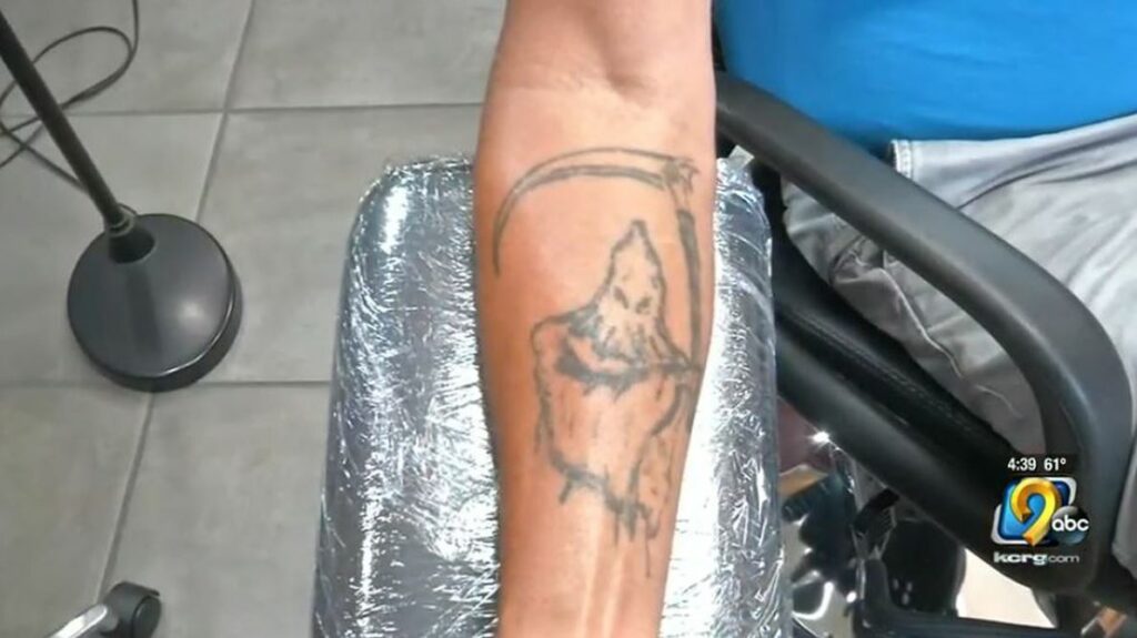 man trying to cover up his Ku Klux Klan gang tattoo