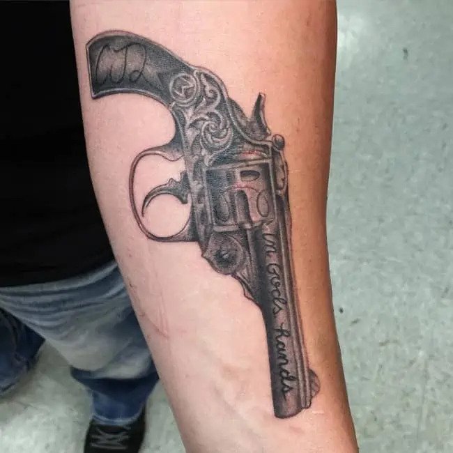 in gods hand gun tattoo design