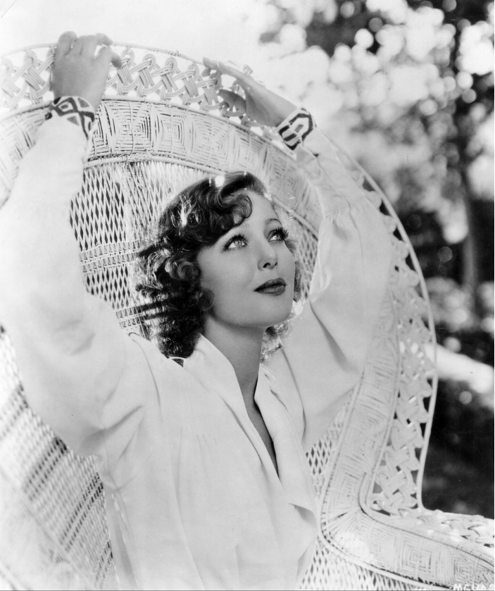 Actress Loretta Young Sitting on a classic Peacock chair, circa 1930.
