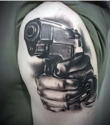 hands with firearm male gangster upper arm tattoos 
