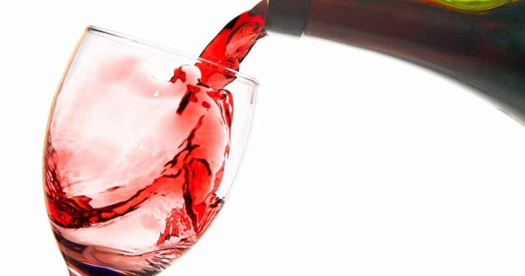 pouring red wine in a glass