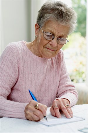 Old women noting details behind a family heirloom