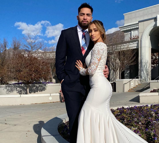 Manti Te'o posing with his wife, you can see Manti Te'o net worth reflected in his smile.