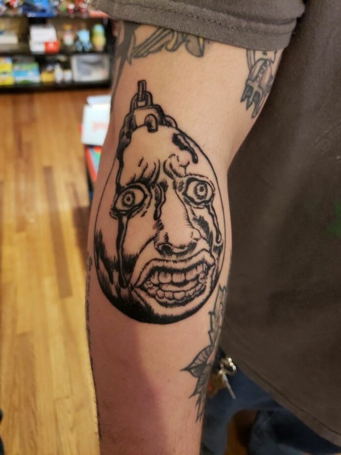 behelit berserk tattoo on arm