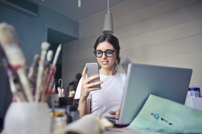 Girl smiling and reading about mobile apps benefits for business