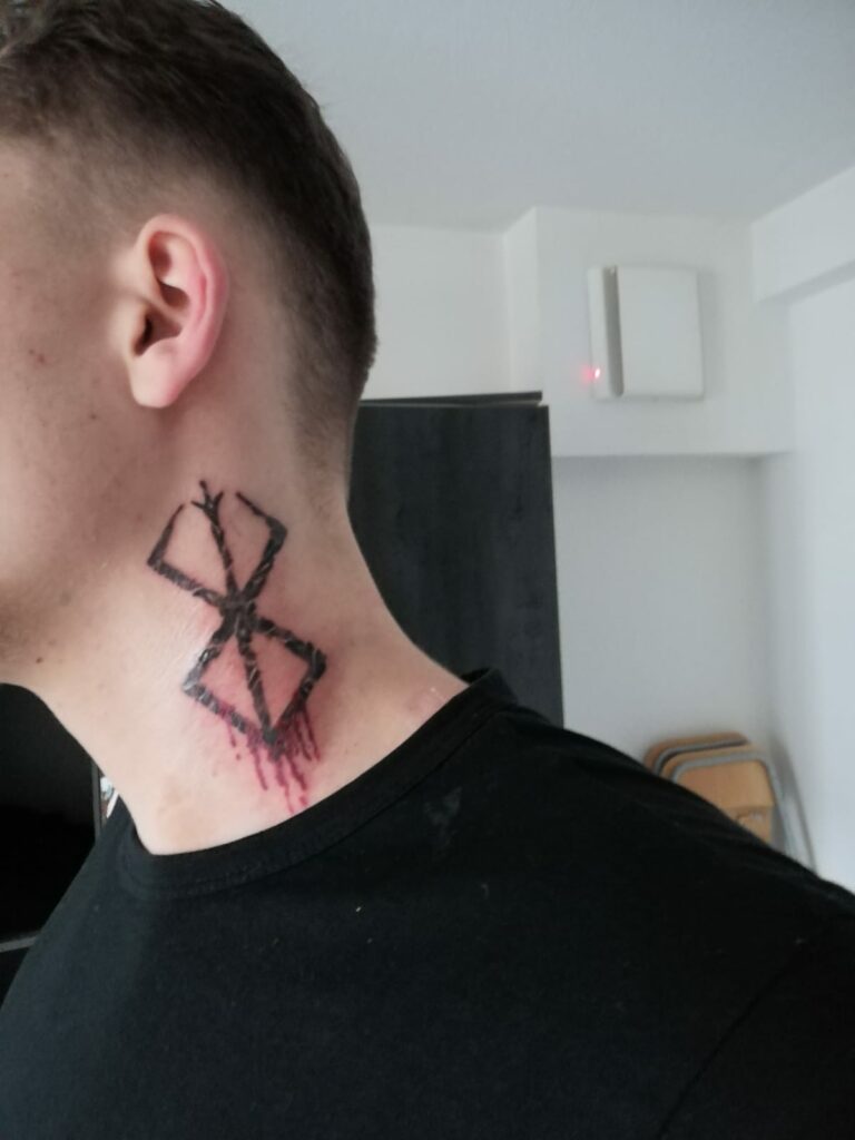 young boy flaunting his Brand of Sacrifice Berserk Tattoo on neck