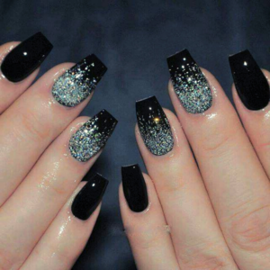 A close-up of short square velvet black nails featuring silver magnetic shimmer