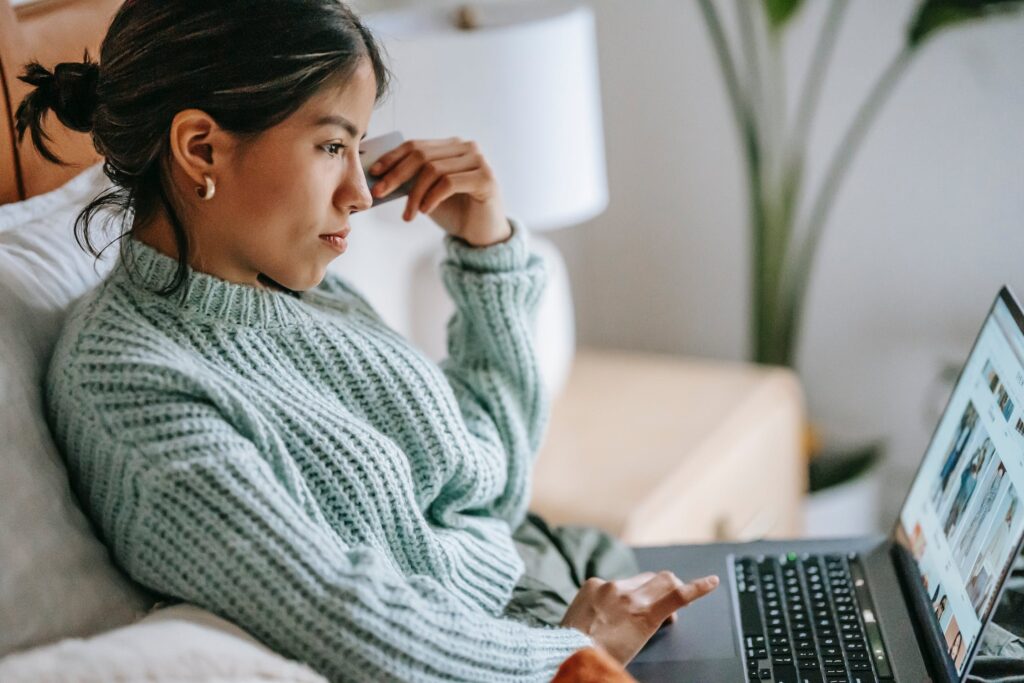 Woman using a laptop to send money internationally 
